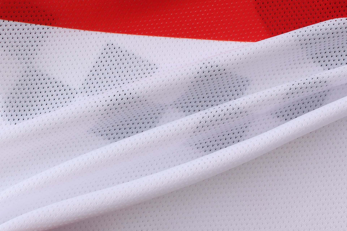 Close-up view of Macboro 69 Jersey with vented polyester mesh fabric and red background.