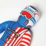 Cute Lil Ronnie Merica plush doll in red, white, and blue design, wearing a racing helmet and star-patterned outfit.
