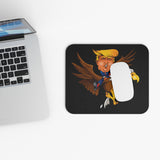 Trump riding a screaming eagle mouse pad on a modern desk with laptop, symbolizing resilience and leadership.
