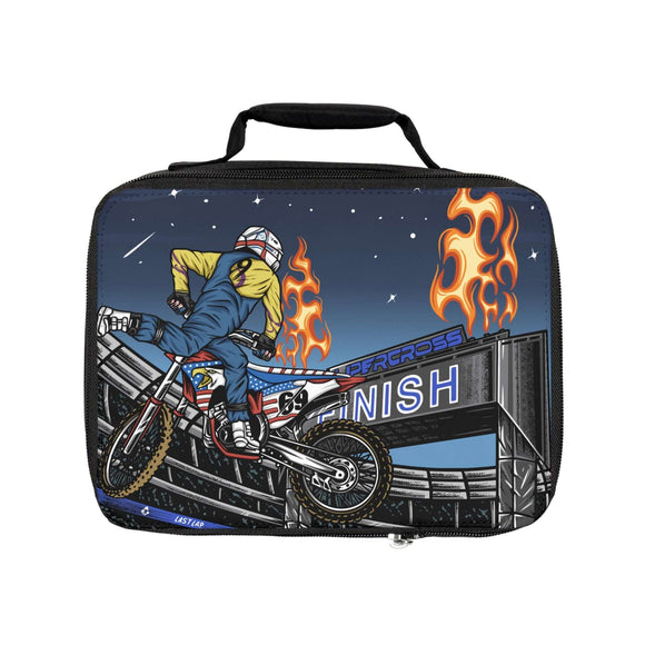 Ronnie Mac Supercross Lunch Box with graphic of Mac Nac stunt at finish line, featuring flaming fire pillars and nighttime sky backdrop