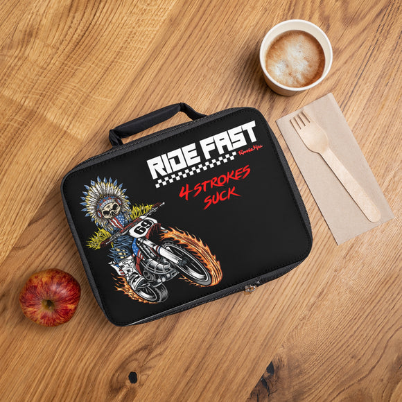 King of Moto Skeleton Ronnie Mac lunch box with moto design, placed on table with apple, coffee, and wooden utensils.