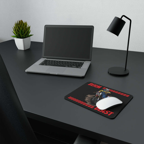 Berm Blast Non-Slip Gaming Mouse Pad featuring Ronnie Mac displayed on a modern desk setup with a laptop and desk lamp.