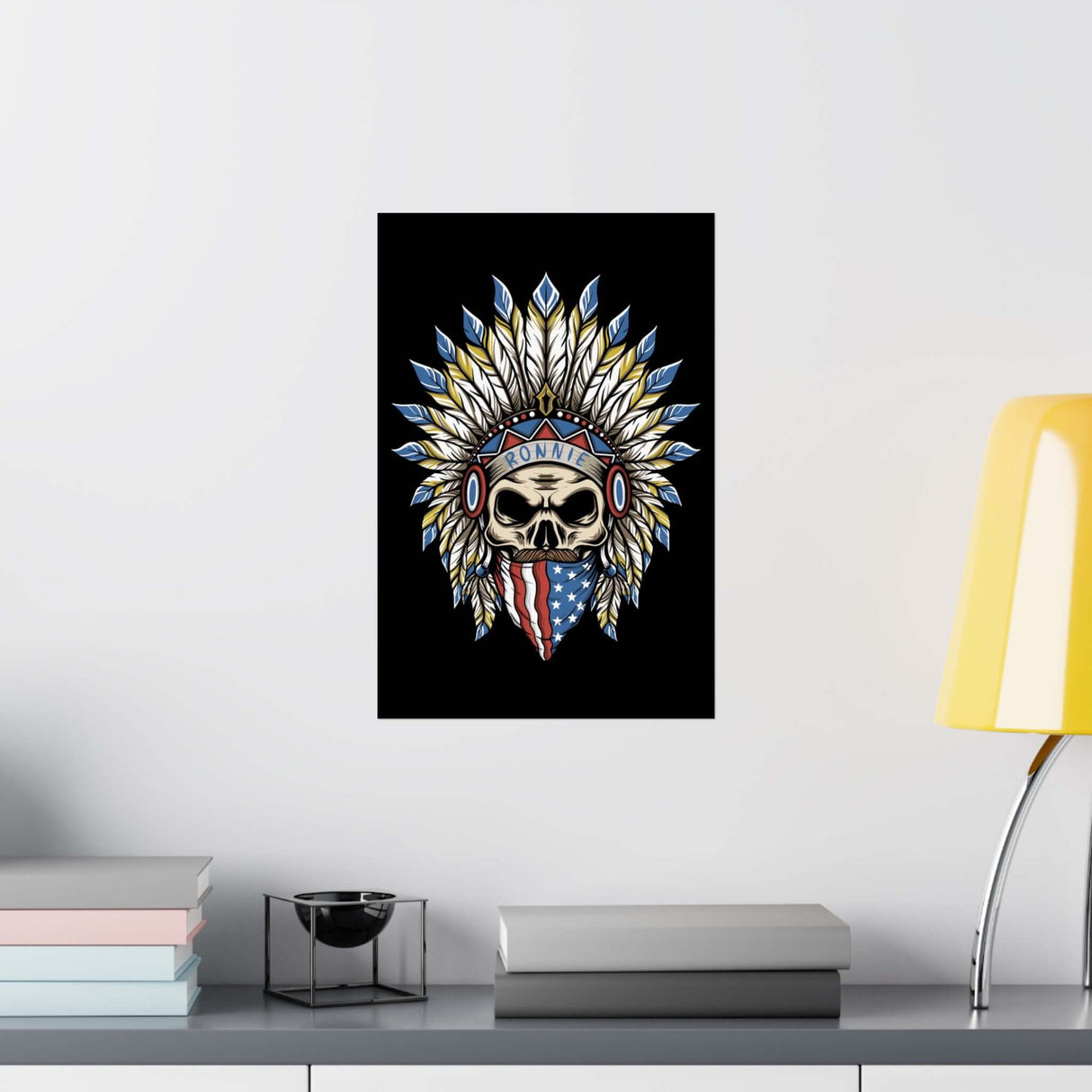 Skeleton Ronnie Mac Head Poster with American bandana and feathered hat displayed on a desk with books and a yellow lamp