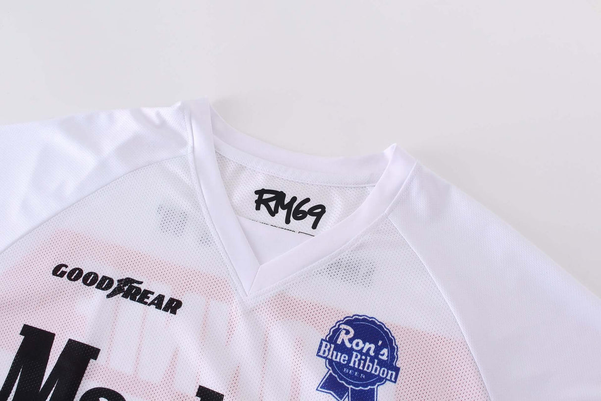 Close-up view of Macboro 69 Jersey showing RM69 logo, white polyester mesh material, and sponsor logos on the front.