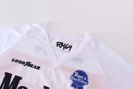 Close-up view of Macboro 69 Jersey showing RM69 logo, white polyester mesh material, and sponsor logos on the front.