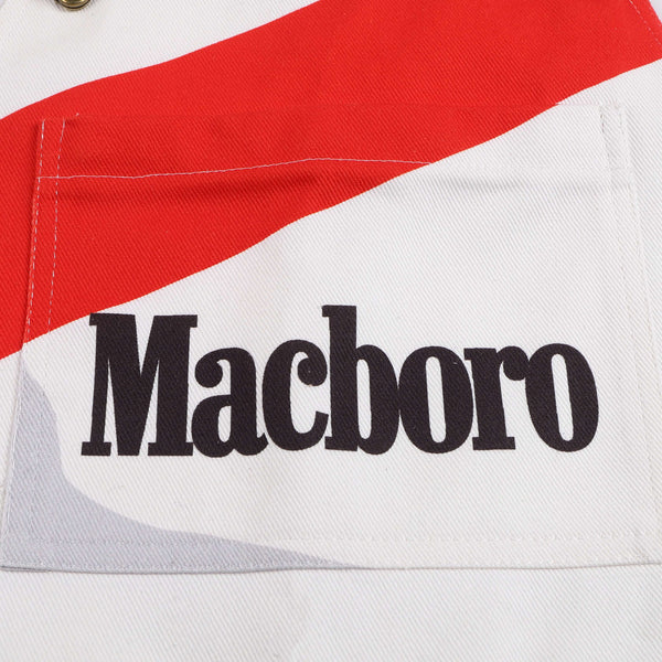 Close-up of Macboro overalls pocket featuring bold logo in black text on red and white fabric