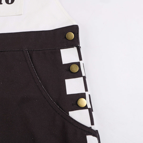 Close-up of Macboro Overalls showcasing durable black and white checkered design with gold buttons and pocket detailing.