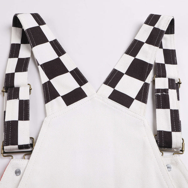 Close-up of Macboro Overalls with black and white checkered straps.