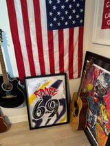Ronnie Mac autographed jersey framed, displayed with an American flag and guitars in a sports memorabilia collection.
