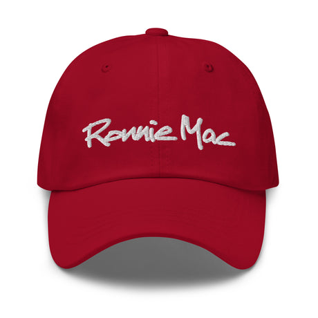 Red Ronnie Mac embroidered dad hat with white signature, 100% chino cotton twill, low-profile design, adjustable antique buckle.