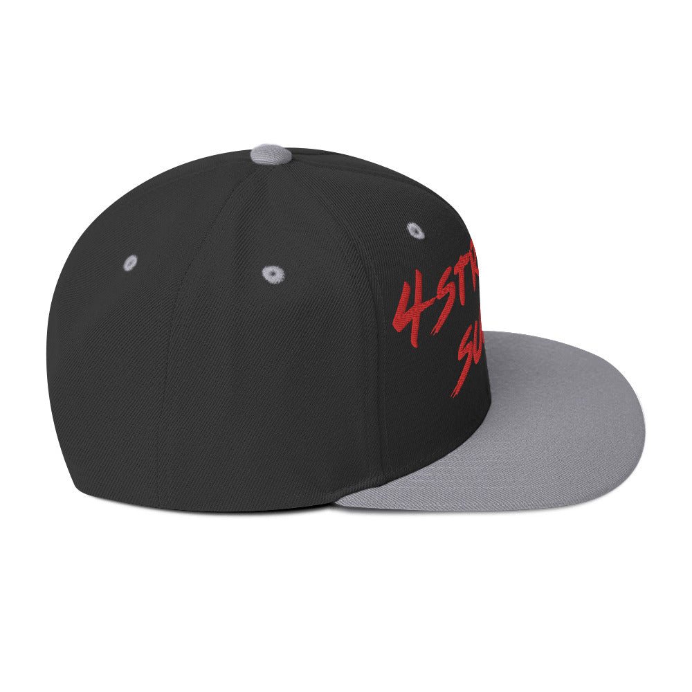 Side view of "4-Strokes Suck" embroidered snapback hat with black panels and grey flat brim.