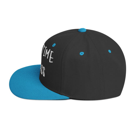 Side view of black and blue "Fulltime Badass" embroidered snapback hat with flat brim and structured design.