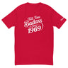 Full-time Badass Since 1969 T-Shirt in red for moto enthusiasts, featuring bold white lettering and Ronnie Mac signature on the sleeve.
